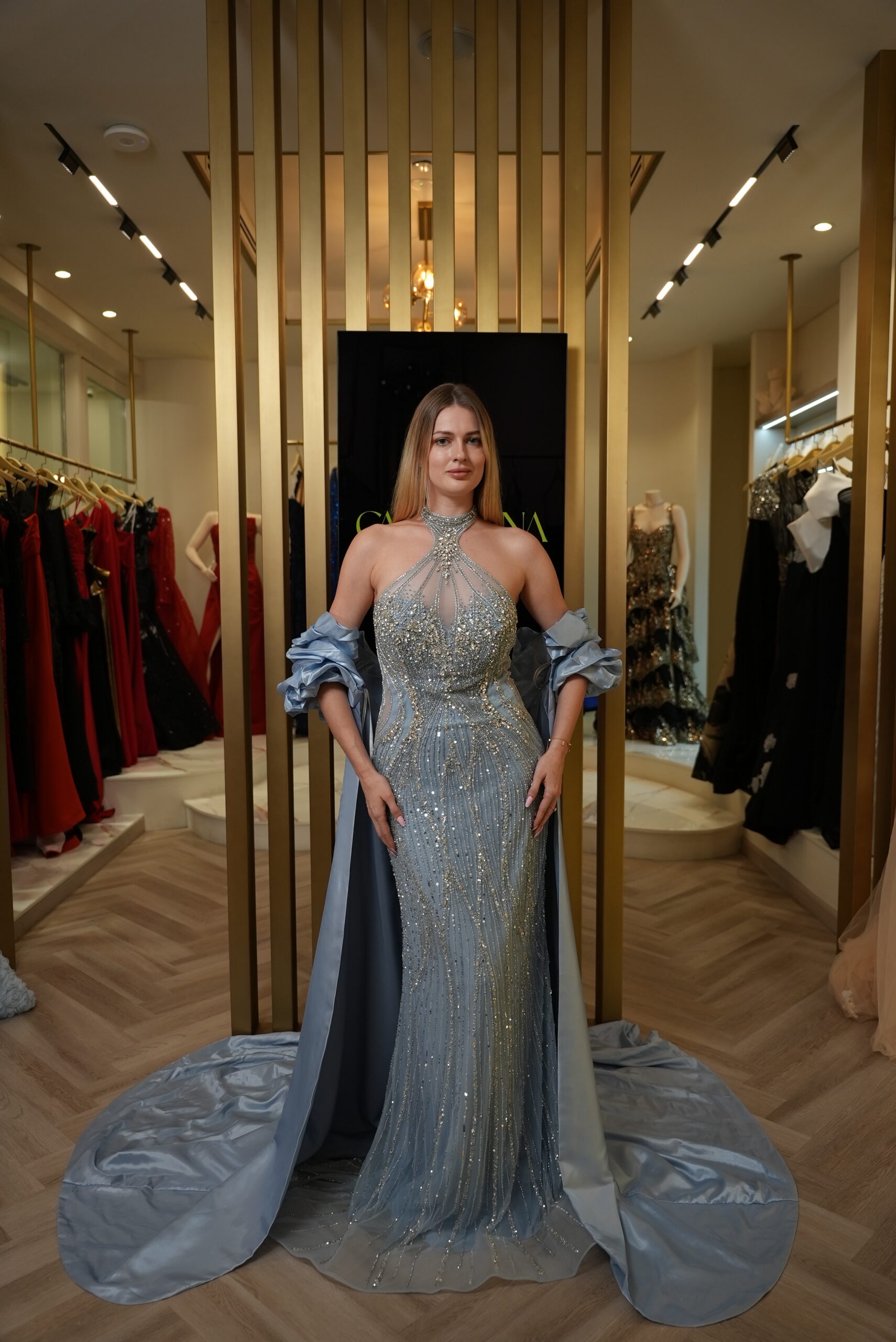 Model wearing an embellished halter evening gown with detachable satin cape in Ice Blue – Casa Reina Boutique