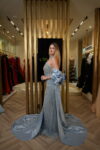 Model wearing an embellished halter evening gown with detachable satin cape in Ice Blue – Casa Reina Boutique