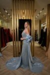 Model wearing an embellished halter evening gown with detachable satin cape in Ice Blue – Casa Reina Boutique