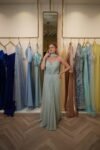 Model wearing a mint green strapless chiffon gown with sweetheart neckline, draped skirt, and detachable scarf detail – Casa Reina Boutique