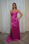 Model wearing a strapless satin corset evening gown with draped bodice and thigh-high slit, available in emerald green – Casa Reina couture collection.