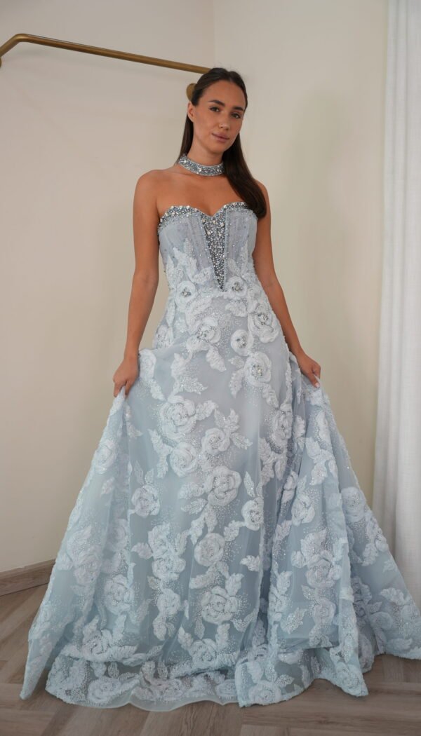 Model wearing an ice blue strapless evening gown with crystal-encrusted bodice, floral lace embroidery, and matching choker – Casa Reina Boutique