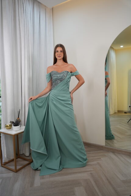 Model wearing a seafoam green off-shoulder evening gown with beaded sweetheart bodice and draped chiffon skirt – Casa Reina Boutique