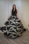 Black and ivory abstract print ball gown with embellished waist and voluminous skirt.