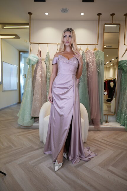 Model wearing a lilac satin off-shoulder evening gown with beaded sweetheart bodice, draped waist, and slit skirt – Casa Reina Boutique