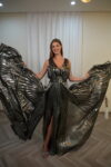 Full-length metallic gunmetal pleated gown with cinched jeweled waist and dramatic wide-flowing skirt – Casa Reina.