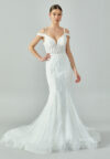 Bride wearing a beaded mermaid gown with illusion V-neckline and off-shoulder straps from Casa Reina Bridal Collection