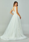 Bride wearing a lace-embroidered fit and flare gown with illusion straps and chapel-length tulle train from Casa Reina Bridal Collection
