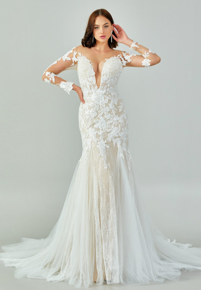 Bride wearing a regal long-sleeved ball gown with beaded embroidered bodice and illusion neckline from Casa Reina Bridal Collection
