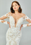 Bride wearing a regal long-sleeved ball gown with beaded embroidered bodice and illusion neckline from Casa Reina Bridal Collection
