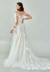 Bride wearing a regal long-sleeved ball gown with beaded embroidered bodice and illusion neckline from Casa Reina Bridal Collection