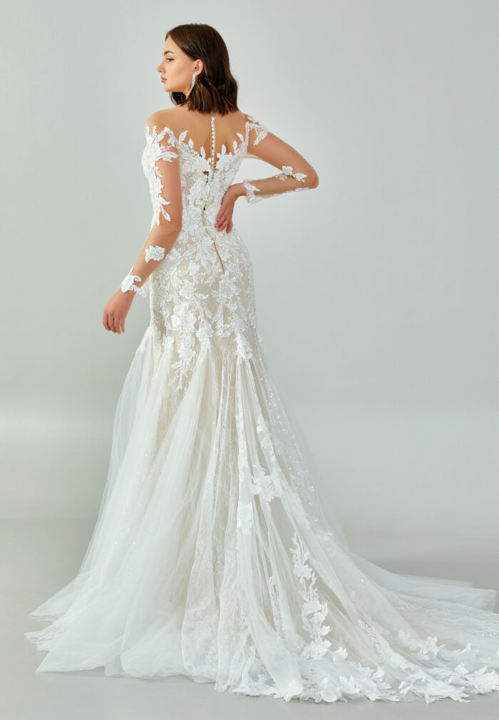 Bride wearing a regal long-sleeved ball gown with beaded embroidered bodice and illusion neckline from Casa Reina Bridal Collection