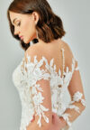 Bride wearing a regal long-sleeved ball gown with beaded embroidered bodice and illusion neckline from Casa Reina Bridal Collection