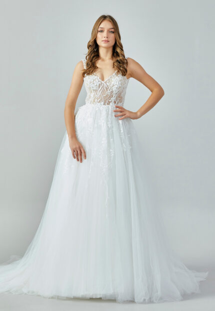 Bride wearing an ivory illusion lace and tulle A-line gown with deep V neckline and chapel train from Casa Reina Bridal Collection