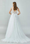 Bride wearing an ivory illusion lace and tulle A-line gown with deep V neckline and chapel train from Casa Reina Bridal Collection
