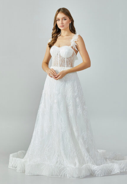 Bride wearing an illusion corset gown with leaf-lace embroidery and flowing tulle skirt from Casa Reina Bridal Collection