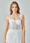 Bride wearing an illusion corset gown with leaf-lace embroidery and flowing tulle skirt from Casa Reina Bridal Collection