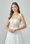 Bride wearing an illusion corset gown with leaf-lace embroidery and flowing tulle skirt from Casa Reina Bridal Collection
