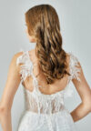 Bride wearing an illusion corset gown with leaf-lace embroidery and flowing tulle skirt from Casa Reina Bridal Collection