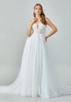 Bride wearing a soft tulle A-line gown with plunging illusion neckline and embroidered bodice from Casa Reina Bridal Collection