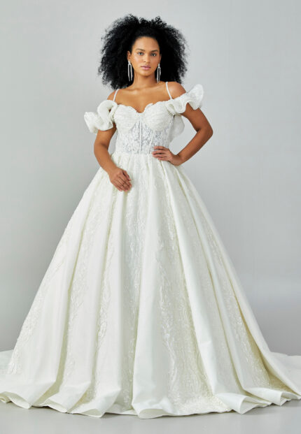 Bride wearing a ruffled off-shoulder ball gown with beaded corset bodice and embroidered jacquard skirt from Casa Reina Bridal Collection