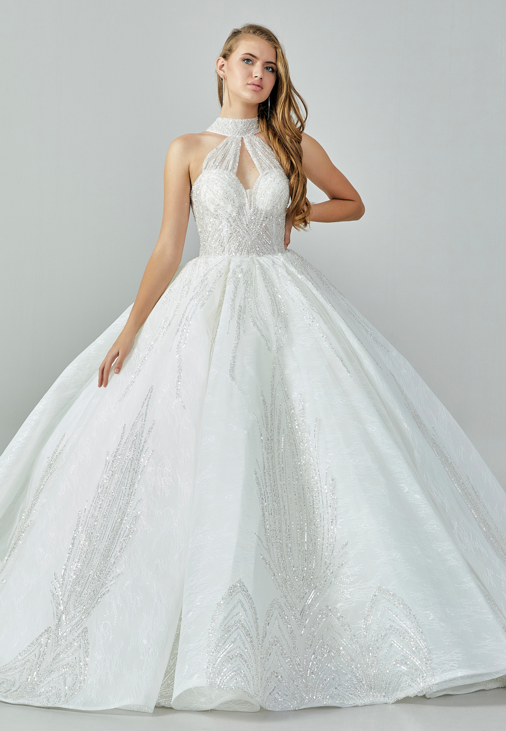 Bride wearing a high-neck crystal ball gown with keyhole bodice and embroidered skirt from Casa Reina Bridal Collection