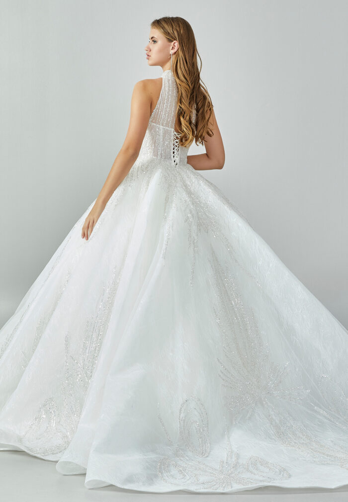 Bride wearing a high-neck crystal ball gown with keyhole bodice and embroidered skirt from Casa Reina Bridal Collection
