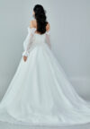 Bride wearing an off-shoulder sculpted organza ball gown with voluminous sleeves and pleated bodice from Casa Reina Bridal Collection