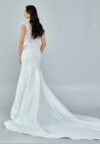 Bride wearing a beaded illusion mermaid gown with cap sleeves and satin skirt from Casa Reina Bridal Collection