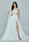Bride wearing a one-shoulder corseted gown with draped tulle and thigh-high slit from Casa Reina Bridal Collection