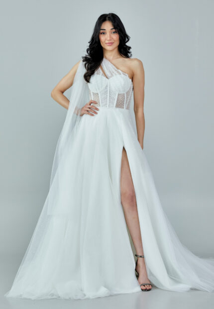 Bride wearing a one-shoulder corseted gown with draped tulle and thigh-high slit from Casa Reina Bridal Collection