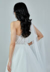 Bride wearing a one-shoulder corseted gown with draped tulle and thigh-high slit from Casa Reina Bridal Collection