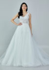 Bride wearing a beaded illusion A-line gown with draped shoulder detail and layered tulle skirt from Casa Reina Bridal Collection