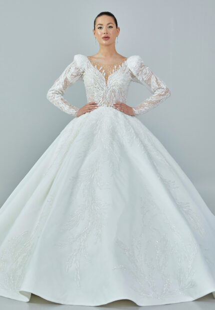 Bride wearing a regal embroidered ballgown with illusion long sleeves and crystal bead detailing from Casa Reina Bridal Collection