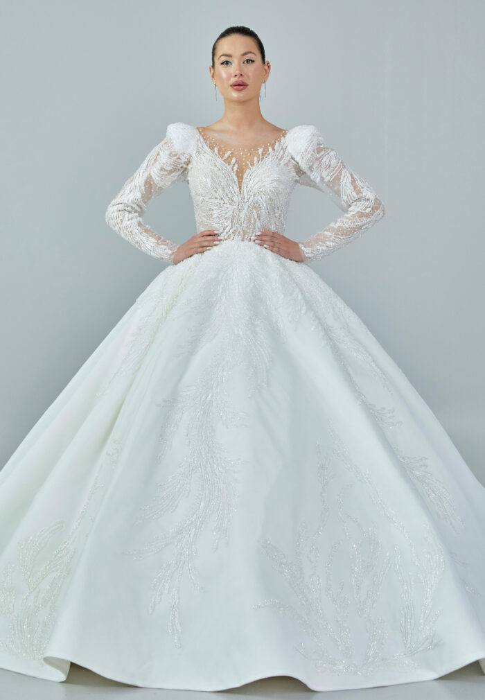Bride wearing a regal embroidered ballgown with illusion long sleeves and crystal bead detailing from Casa Reina Bridal Collection