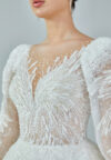 Bride wearing a regal embroidered ballgown with illusion long sleeves and crystal bead detailing from Casa Reina Bridal Collection