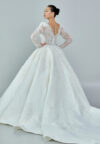 Bride wearing a regal embroidered ballgown with illusion long sleeves and crystal bead detailing from Casa Reina Bridal Collection