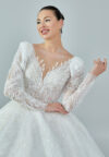 Bride wearing a regal embroidered ballgown with illusion long sleeves and crystal bead detailing from Casa Reina Bridal Collection
