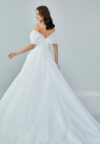 Bride wearing an off-shoulder organza ball gown with draped bodice and full skirt from Casa Reina Bridal Collection