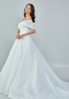 Bride wearing an off-shoulder organza ball gown with draped bodice and full skirt from Casa Reina Bridal Collection