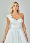 Bride wearing an asymmetrical satin ballgown with draped shoulder and beaded sweetheart neckline from Casa Reina Bridal Collection