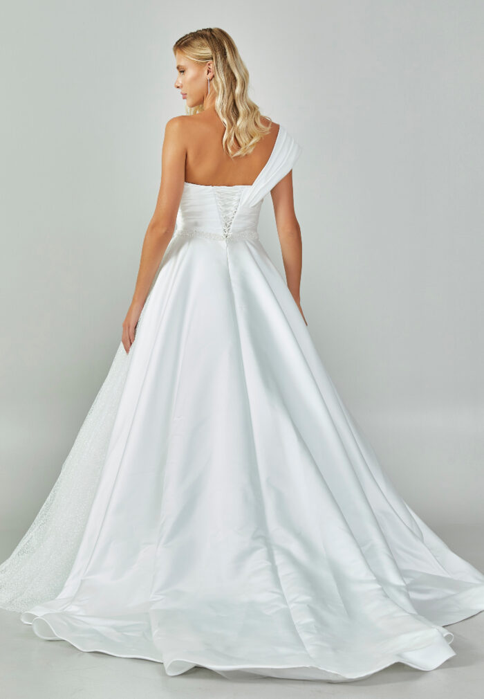 Bride wearing an asymmetrical satin ballgown with draped shoulder and beaded sweetheart neckline from Casa Reina Bridal Collection