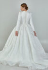 Bride wearing a high-neck long sleeve ball gown with hand-beaded detailing and cathedral train from Casa Reina Bridal Collection