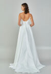 Bride wearing a minimalist satin A-line gown with plunging neckline and structured waist from Casa Reina Bridal Collection